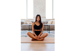 Woman sits cross-legged on the floor, a Sports & Recreation Photo by undrey