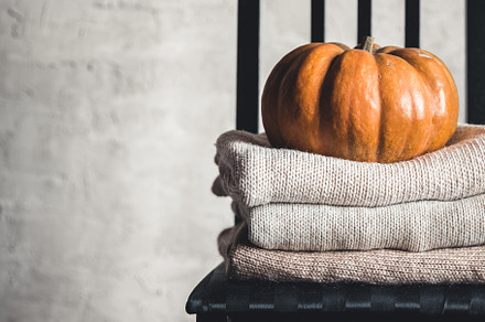 A stack of warm knitted sweaters on