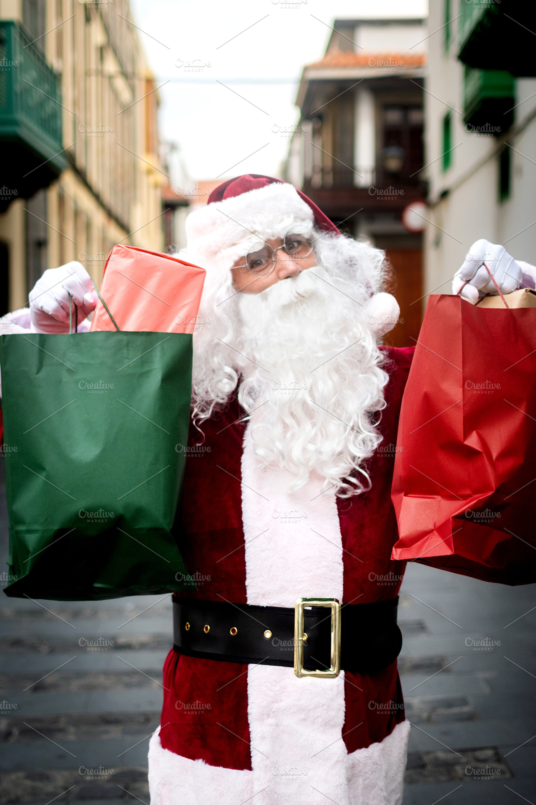 Happy Santa Claus carrying Christmas shopping bags, a Person Photo by etorres69