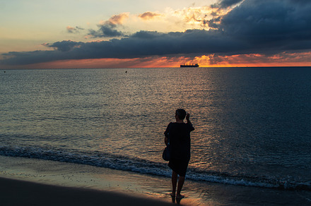 Woman walking on sea shore to see a