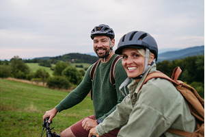 Couple cycling together in nature, a Sports & Recreation Photo by HalfPoint