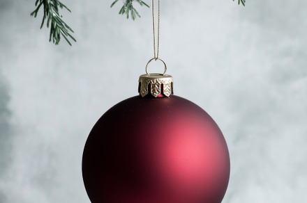 Red Christmas ornament hanging from Christmas tree branch, suita, a Photo by Dvoevnore photos