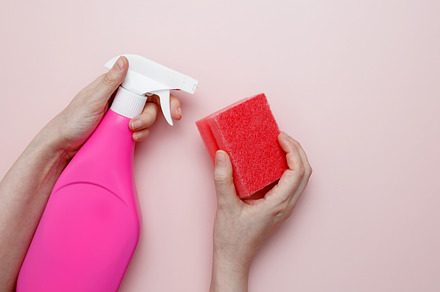 Household cleaning and hygiene concept. Womans hand in holds pink dishwashing s, a Photo by matucha