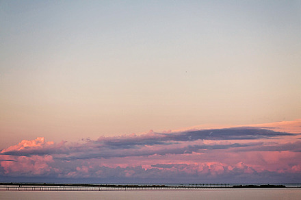 Landscape long bridge over a sea plait on a beautiful pink sunse, a Nature Photo by TanaCh