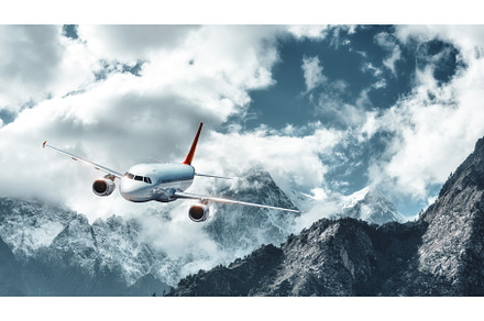 Airplane is flying over low clouds, a Transportation Photo by den-belitsky
