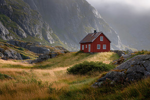 Red house on a hill in a valley, a Photo by Beautiful things