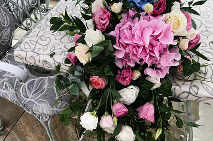 Elegant floral centerpiece with vibrant pink and blue hydrangeas, a Photo by AS photostudio