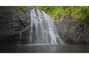 Waterfall rushing down dark rock, a Nature Photo by Goinyk