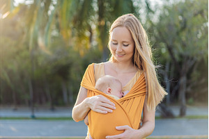 Mother holding her little baby in a, a Person Photo by Elizaveta Galitskaya