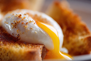 Perfectly cooked egg on toast slice, a Photo by Beautiful things