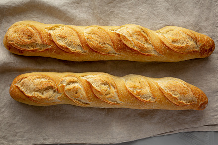 Homemade French Bread Baguette on a gray background, top view., a Food & Drink Photo by LiudmylaChuhunova