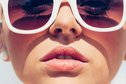 Young female face with sunglasses featuring sunglasses, close-up, and woman