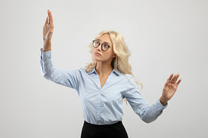 Business innovations concept. Young female entrepreneur touching virtual screen, a Photo by Prostock-Studio