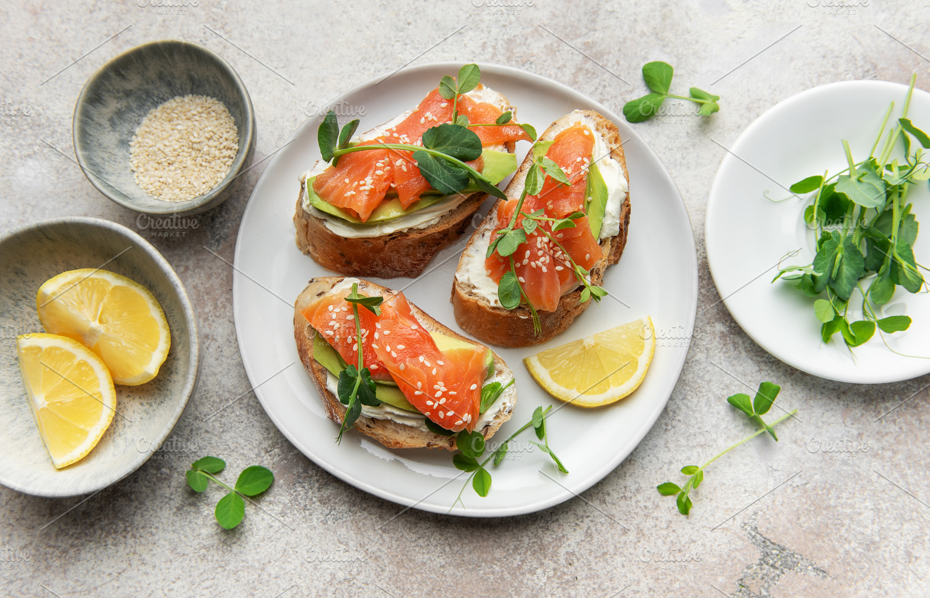 Salmon avocado toasts with microgreens and lemon, a Food & Drink Photo by Olena Rudo