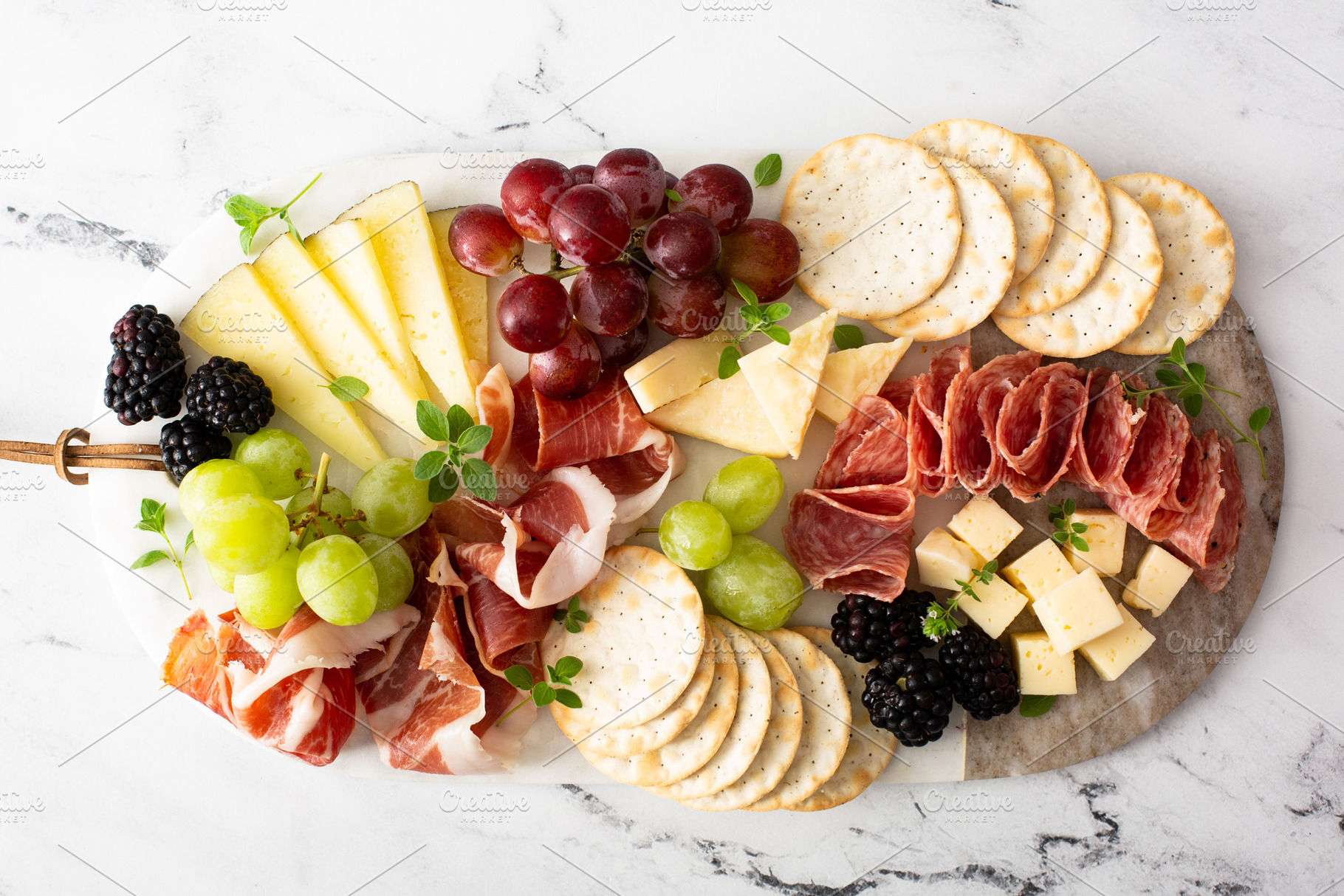 Charcuterie board with variety of cheese and meat, a Food & Drink Photo by farwasser
