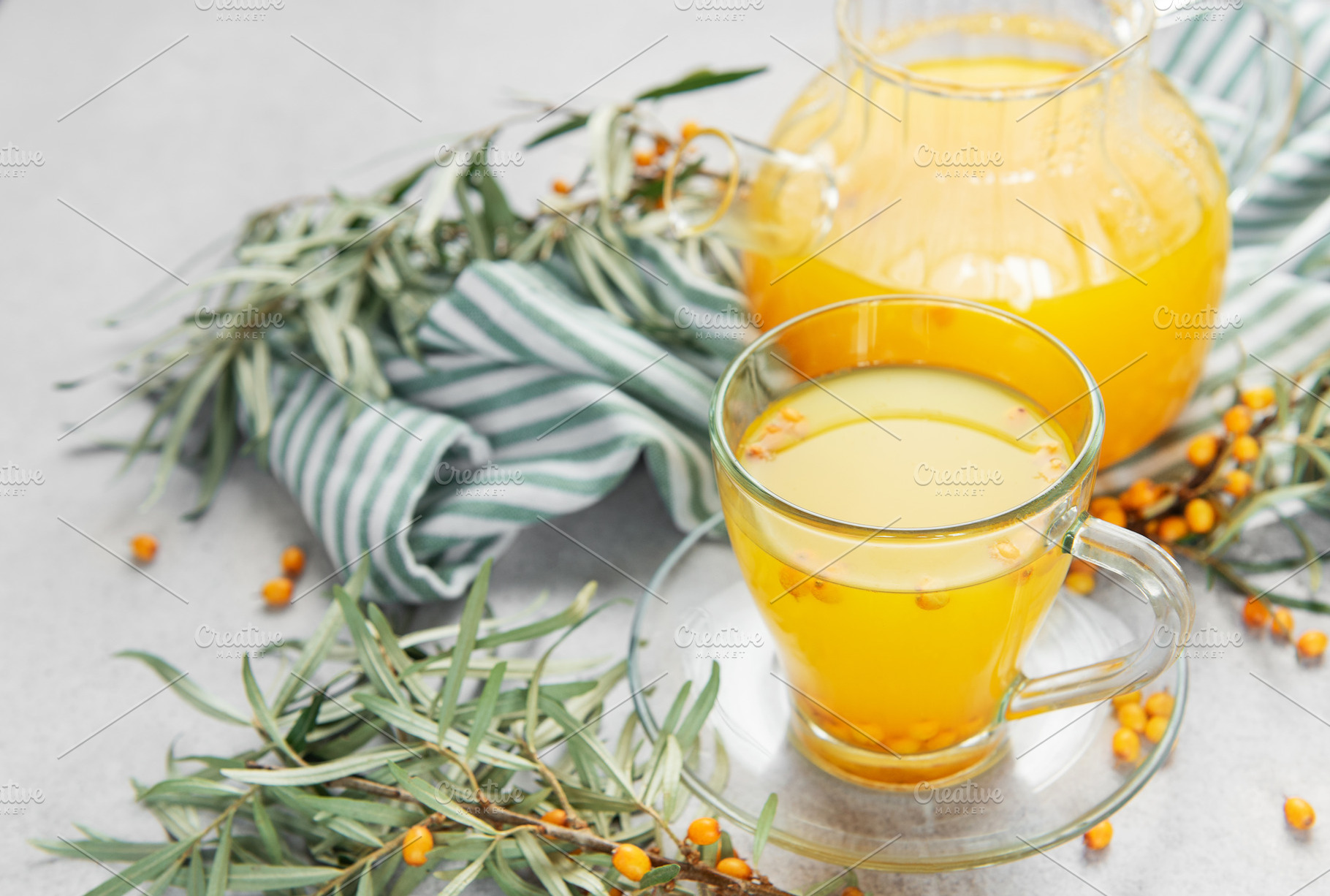 Sea buckthorn berry tea in glass cup and teapot, a Food & Drink Photo by Olena Rudo