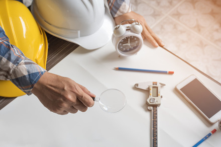 Engineer with magnify glass for looking blank paper for new proj, an Industrial Photo by Ministocker