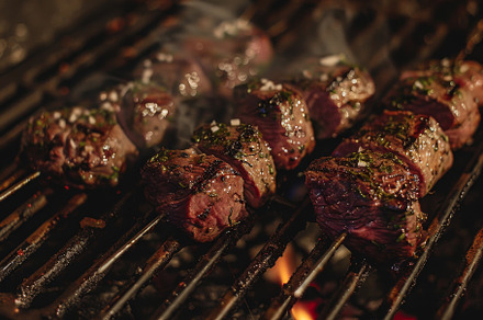 A detailed view of meat cooking on a, a Photo by Iftikhar Alam