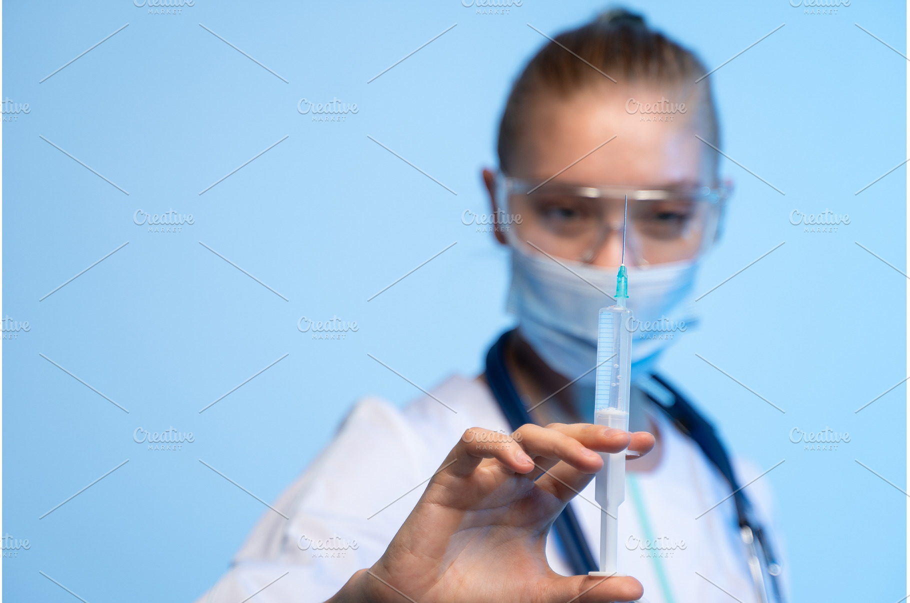 Healthcare worker holding syringe, a Health & Medical Photo by volodymyrshtun13795