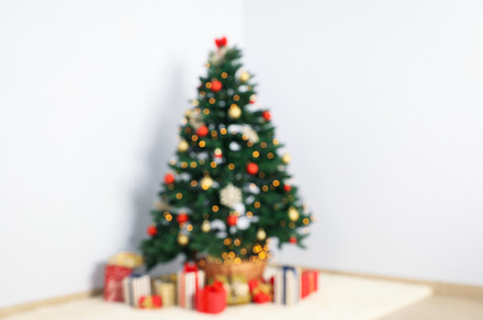 Christmas tree with garland and gift boxes in room, blurred back, a Holiday Photo by AtlasStudio PRO
