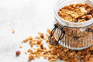 Granola cereal in glass jar for healthy breakfast, a Food & Drink Photo by Olena Rudo