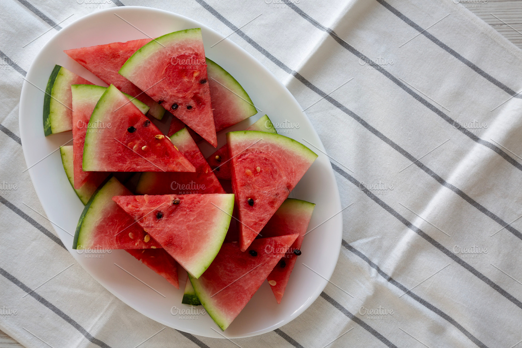Raw Organic Watermelon Slices on a Plate, top view. Copy space., a Food & Drink Photo by LiudmylaChuhunova