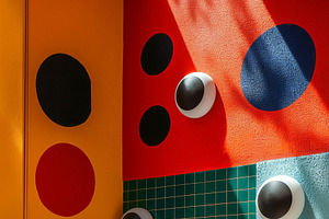 Colorful abstract wall with geometric patterns and playful eyes, a Decorative Illustration by ImageMir