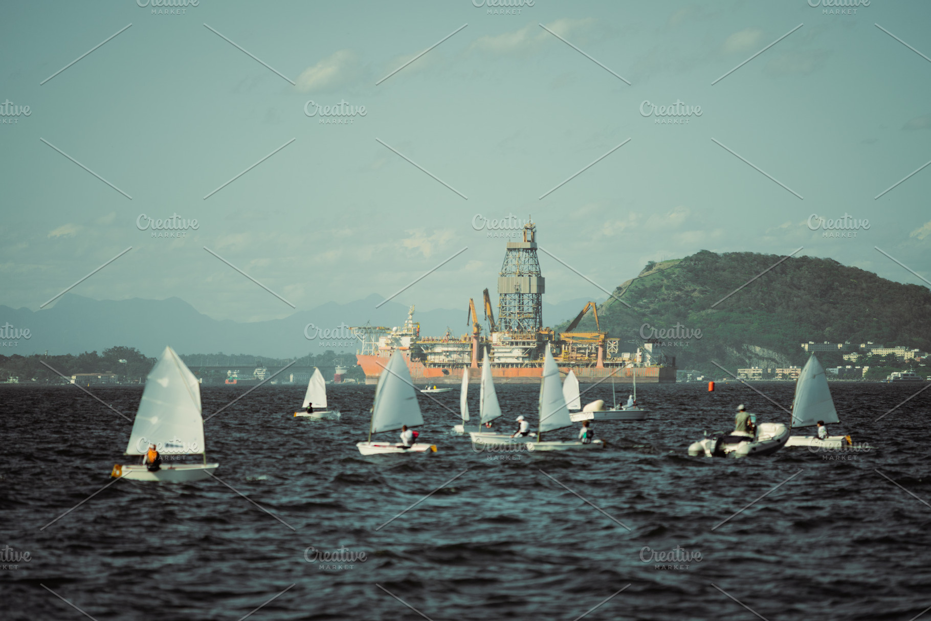 Oil platform and blurred sailboats, a Holiday Photo by SkyNext