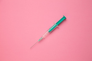 Medical syringe on colorful backgrou