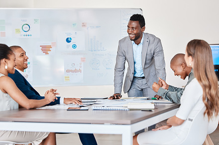 Presentation or business people planning in a meeting and working in an office together. African American accountant talking company growth strategy with a corporate team discussing data and graphs, a Photo by Peopleimages.com