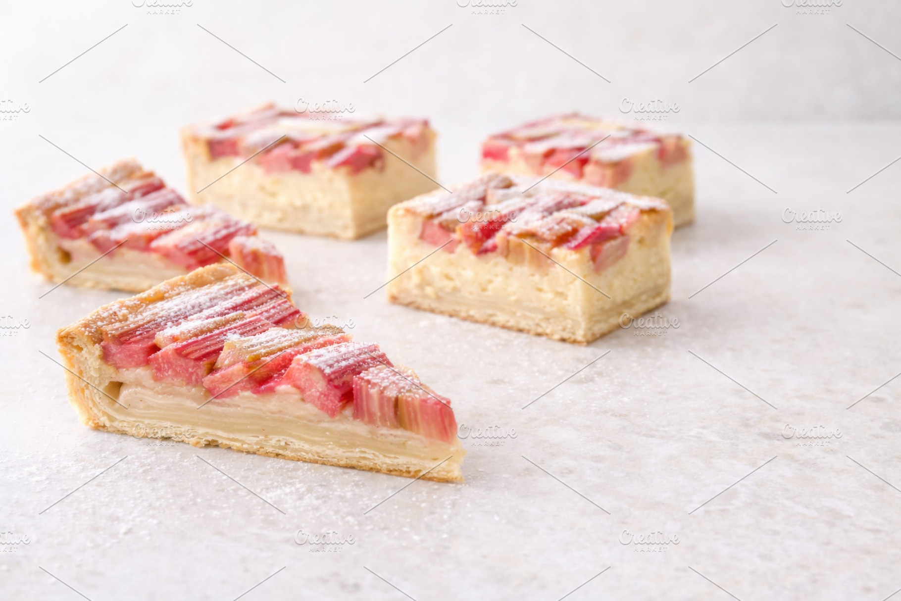 Slices of rhubarb pie on light stone, a Photo by Dvoevnore photos
