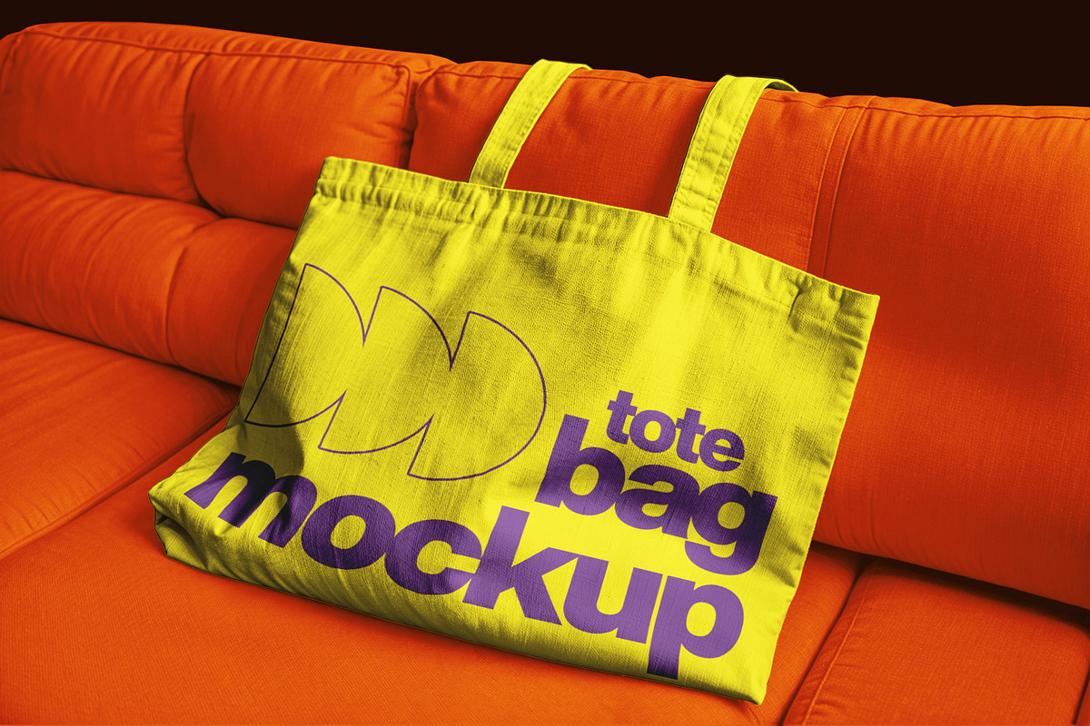 Totebag on Sofa, an Apparel Mockup by sagesmask.com (Photo 1 of 3)