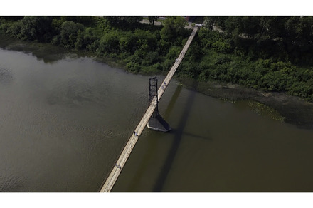Old narrow bridge over a river. Clip, an Architecture Photo by Media Whale Stock