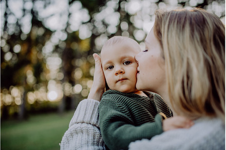 Mother holding and kissing her, a Nature Photo by HalfPoint