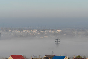 Morning fog partially covering town, a Photo by Elena Vagengeim
