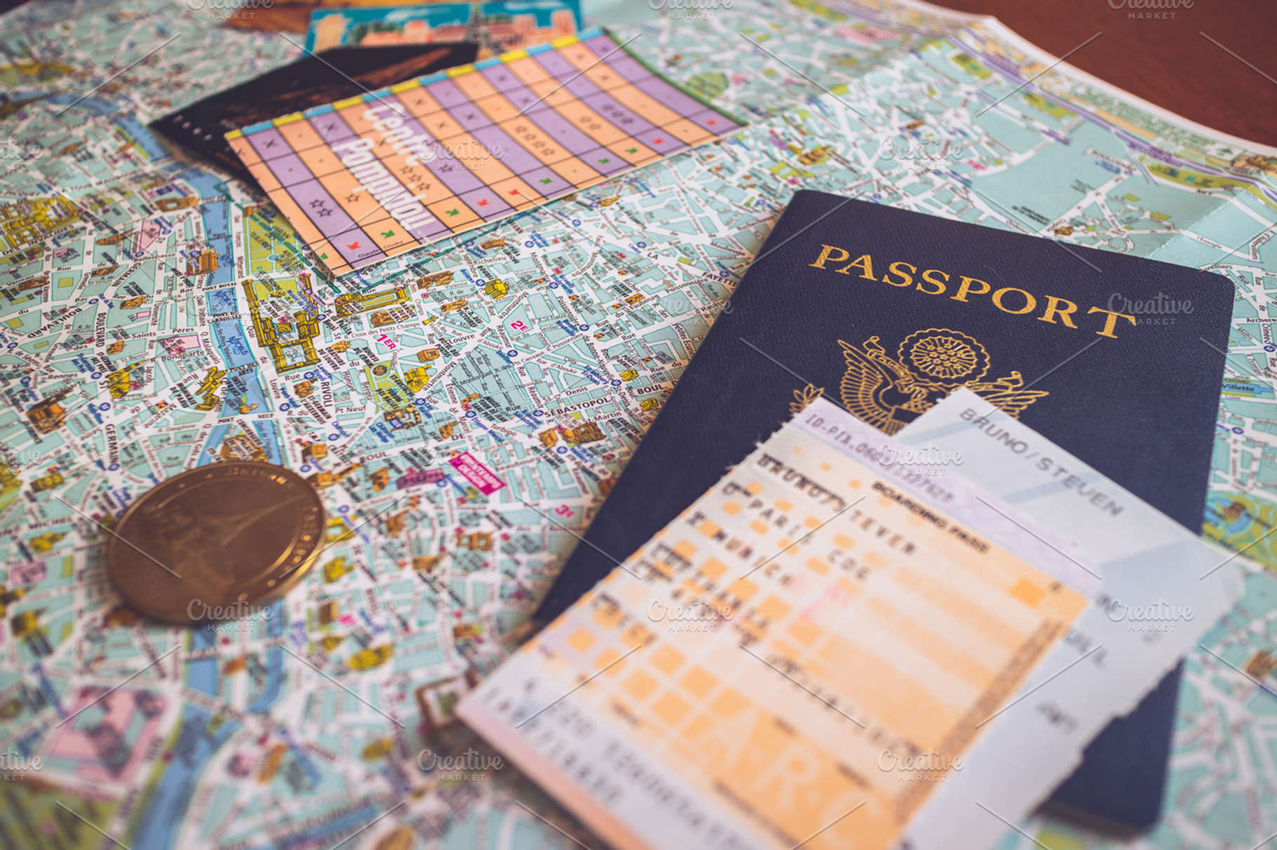 Passport sits on Map of Paris, an Arts & Entertainment Photo by Shots by Sleeven