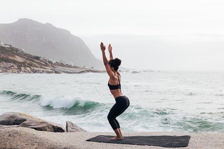 Young woman doing Utkatasana pose, a Sports & Recreation Photo by Artem Varnitsin