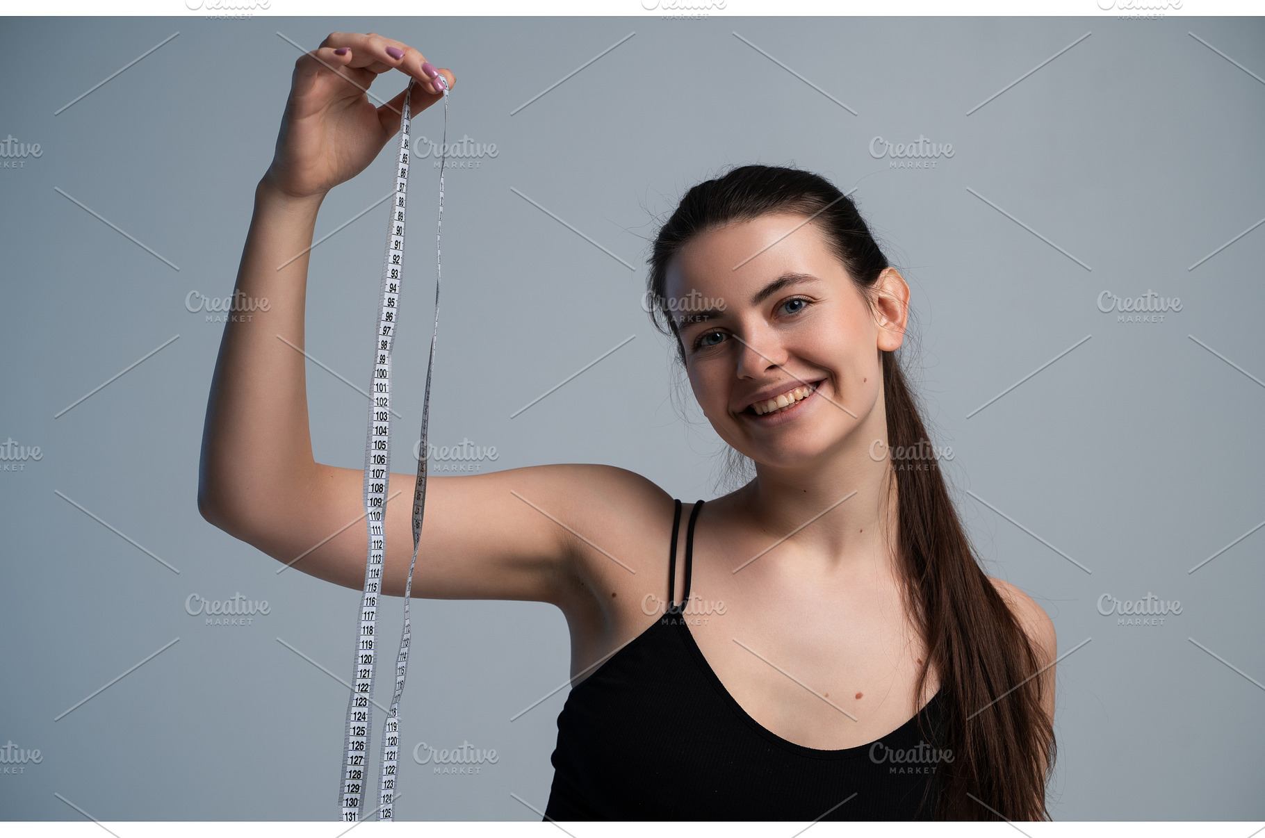 Happy young woman smiling, holding, a Sports & Recreation Photo by volodymyrshtun13795