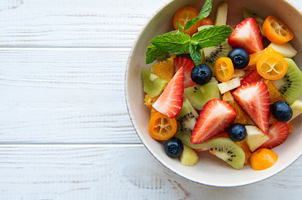 Healthy fresh fruit salad in a bowl, a Food & Drink Photo by Olena Rudo
