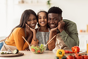 African American Family Of Three Making Salad Cooking Together Indoor, a Photo by Prostock-Studio (Thumbnail 1 of 3)