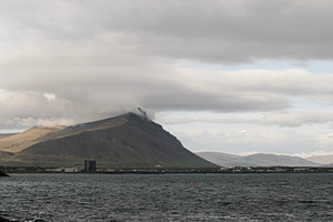 Misty mountain landscape and ocean in Akranes, Iceland under cloudy skies, a Photo by AS photostudio