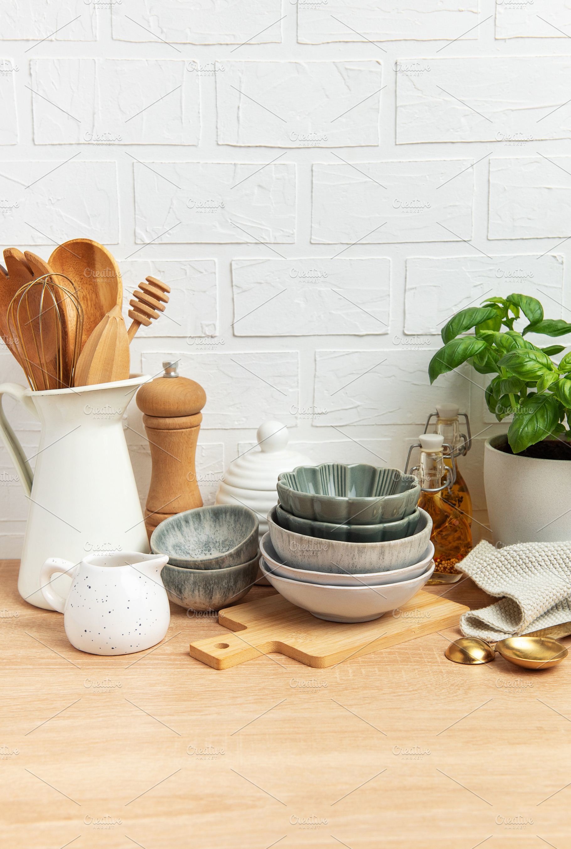 Kitchen utensils and empty bowls resting on wooden countertop in, a Food & Drink Photo by Olena Rudo