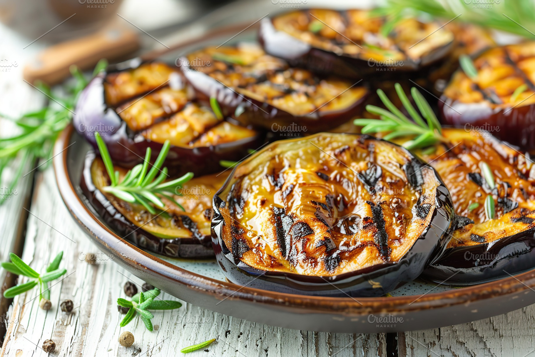 Grilled eggplants in plate on wooden table, a Food & Drink Photo by AlyaAnd