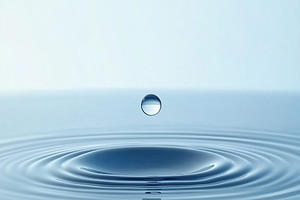 A close-up view of a water droplet creating ripples in a calm body of water, wi, a Photo by Textures & Backgrounds