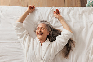 Happy aged woman in a bathrobe, a Person Photo by Artem Varnitsin