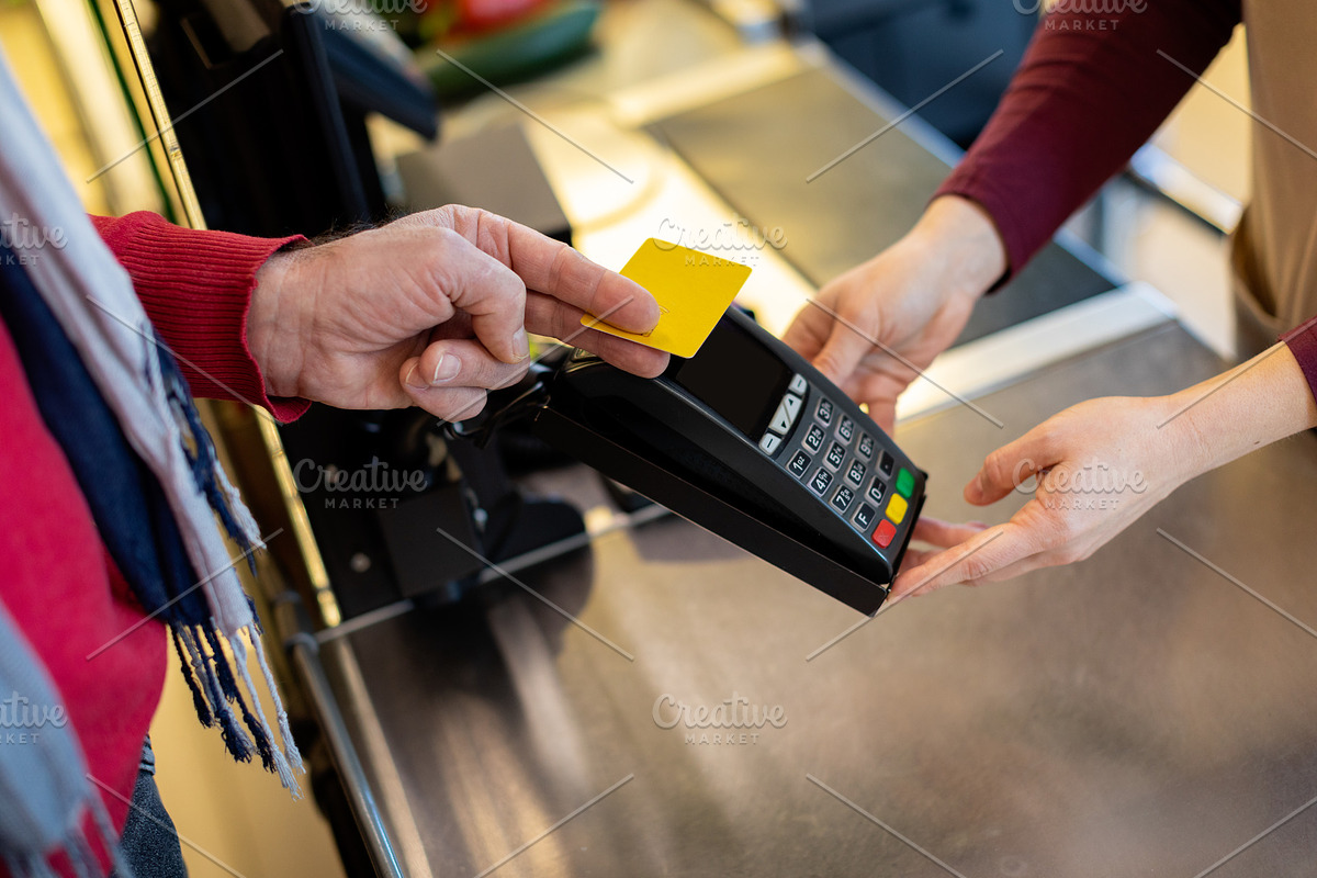 Cropped of male customer paying with credit card, a Photo by Prostock-Studio (Photo 2 of 2)