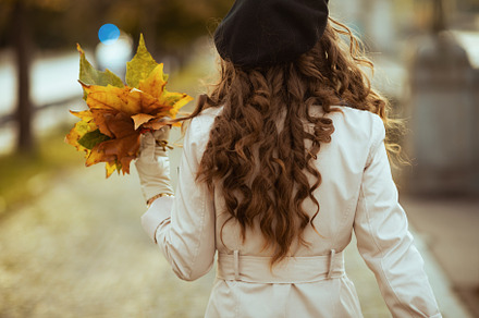 Seen from behind woman in beige trench coat, a Person Photo by Alliance Images