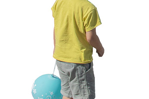 kid standing while holding a glove in one hand, a Person Photo by DanFLCreativo