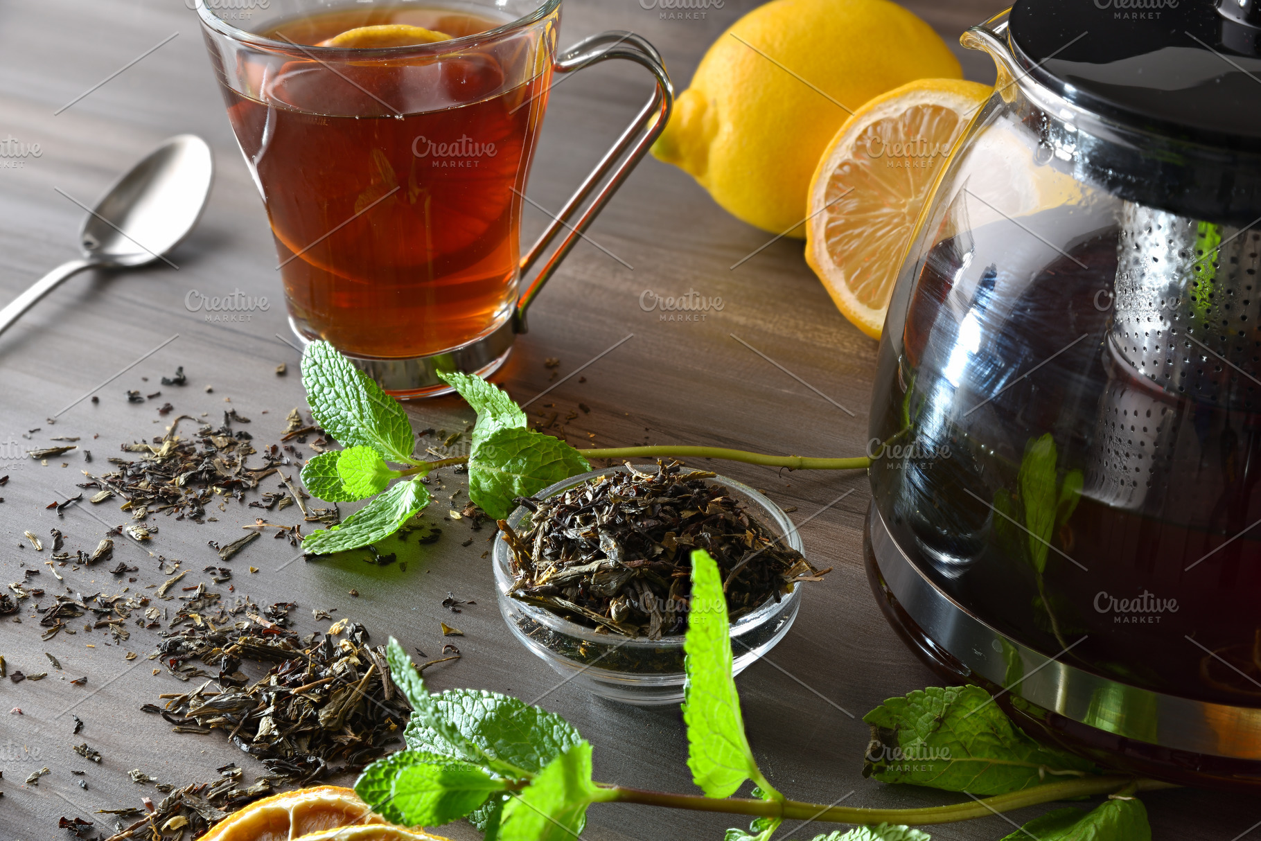 Black tea infusion on a wooden table with ingredients, a Food & Drink Photo by Davizro's Market