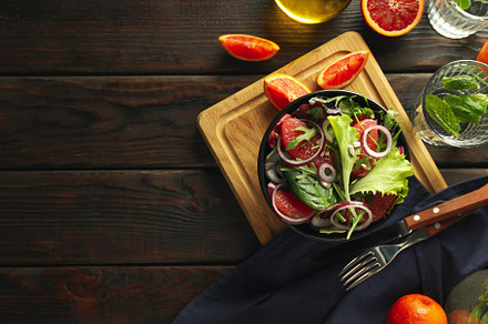 Concept of tasty food, salad with red orange, space for text, a Food & Drink Photo by AtlasStudio